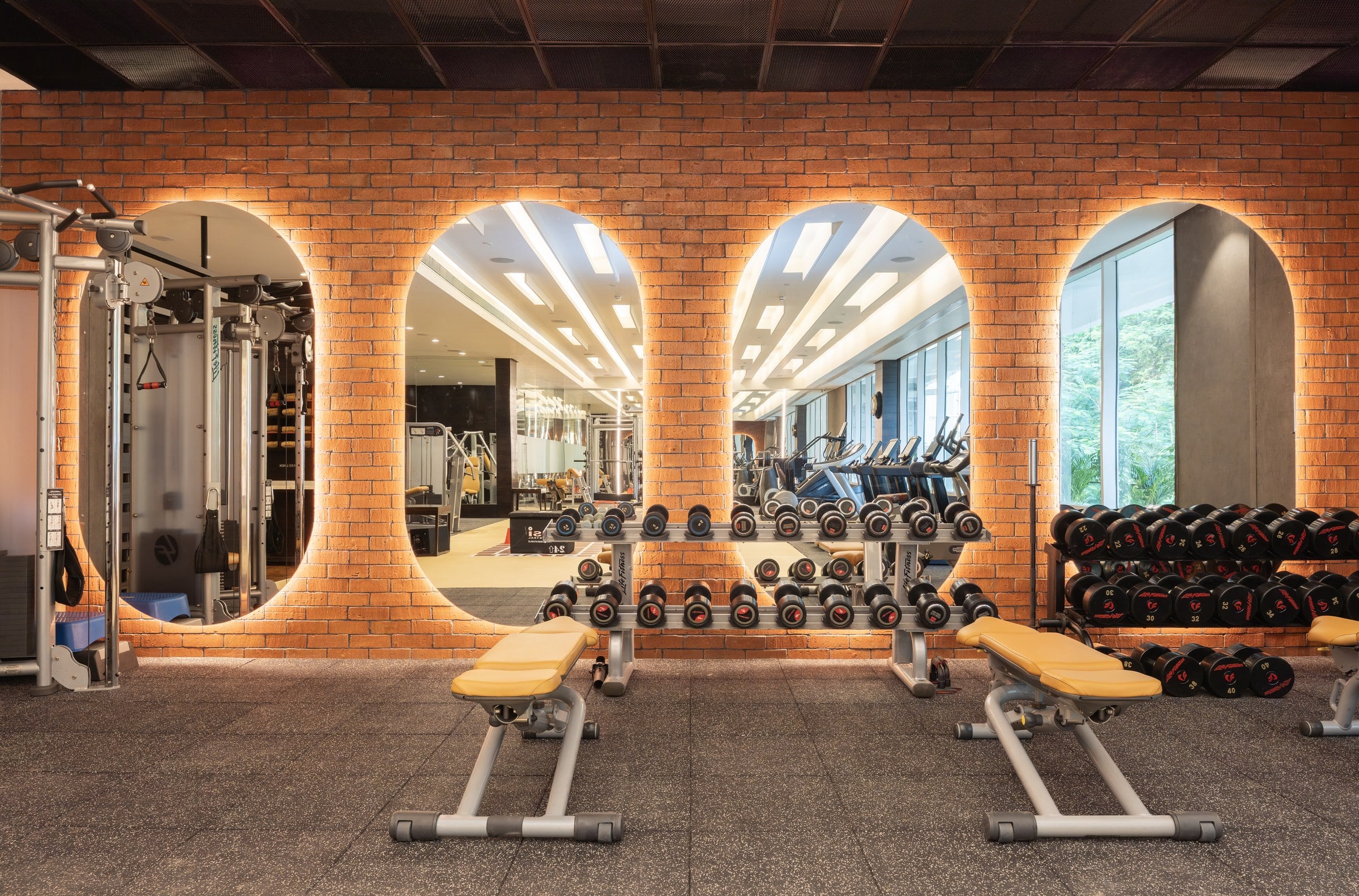 Fitness atelier with lit brick arches