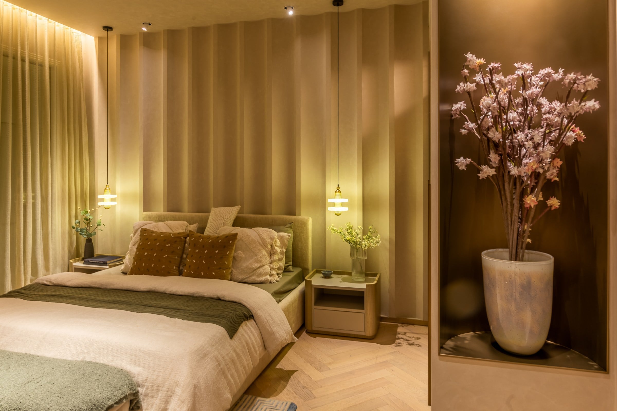 Show residence bedroom in warm evening light at The Imperial i