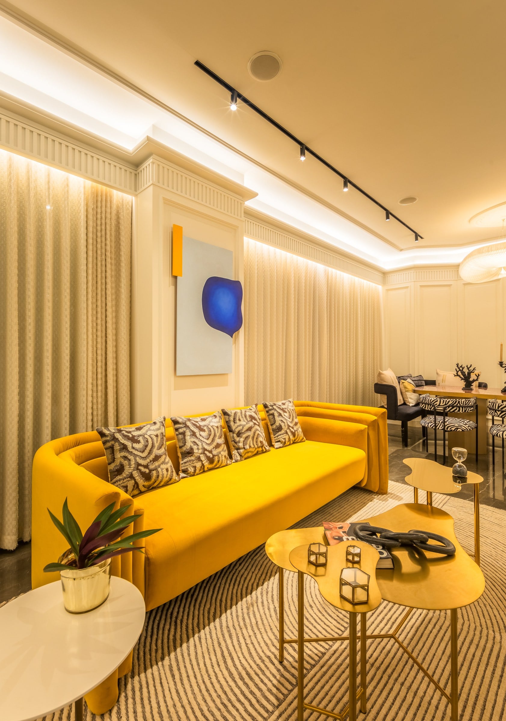 Living room with yellow sofa in the show residence at The Imperial i