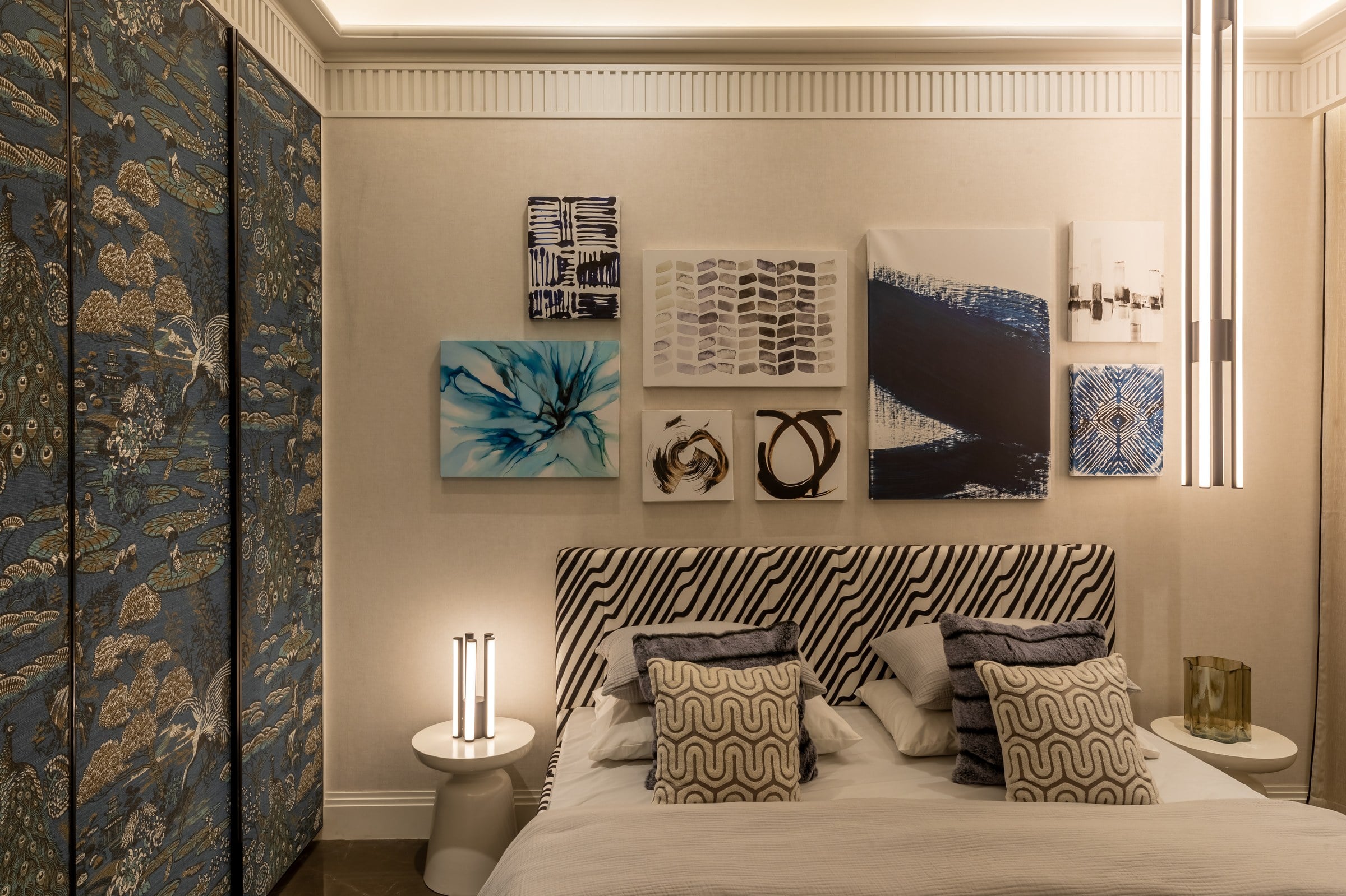 Bedroom with curated art wall in the show residence at The Imperial i